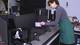Artist-in-Residence Sally Weber adjusts the laser beam apparatus.